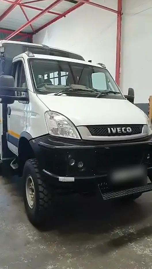 White Iveco Daily 4x4 with a rescue body parked in the workshop