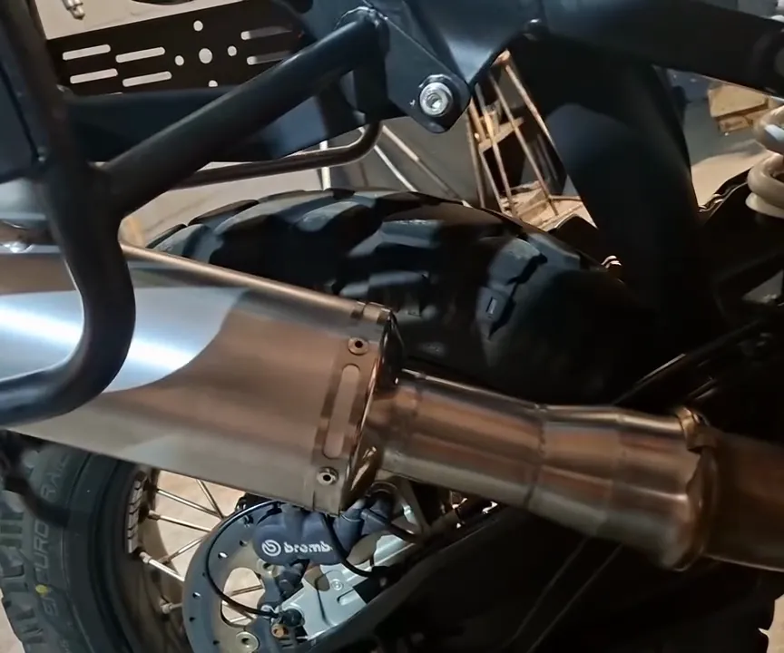 Stainless link pipe and canister on a KTM 1290 Super Adventure R, Brembo caliper behind