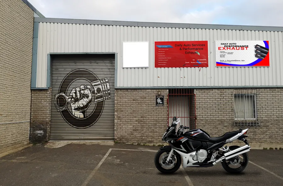 The ACA Automotive unit in Alto Industrial Park: grey cladding, red service signs and the painted roller door