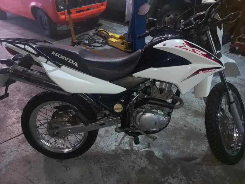 Honda XR125L in the workshop with a BOSSON exhaust fitted